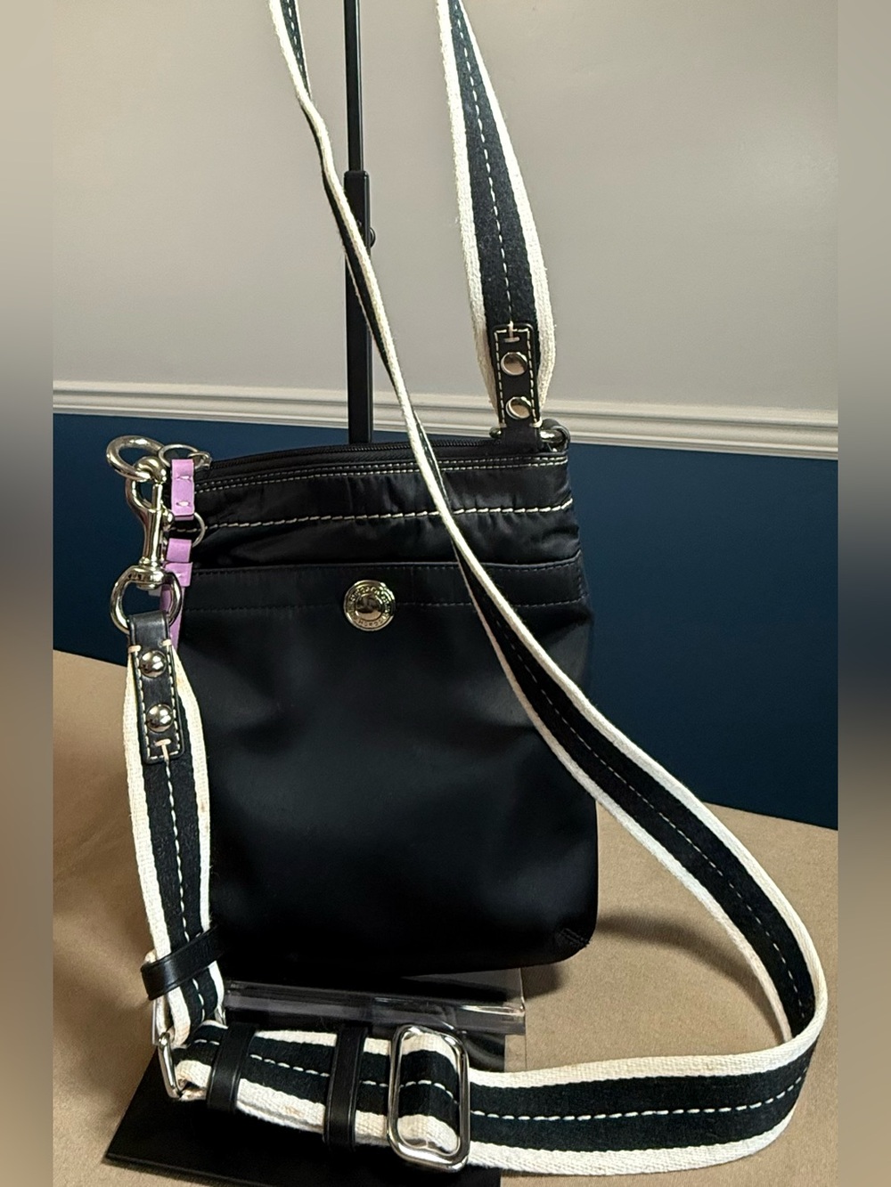 Coach Black Crossbody Bag with White-Trim Strap and Lavender lining.